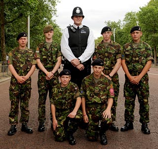 giant london bobby surrounded by military men