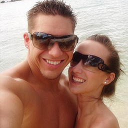 happy couple smiling beach sunglasses